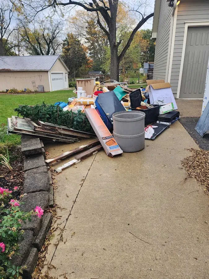 Dumpster being loaded with debris for Estate Cleanout Dumpster Rental in Lisbon